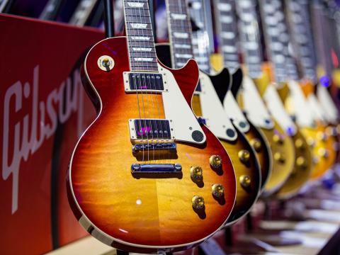 Image of Gibson guitars lined up in front of one another.