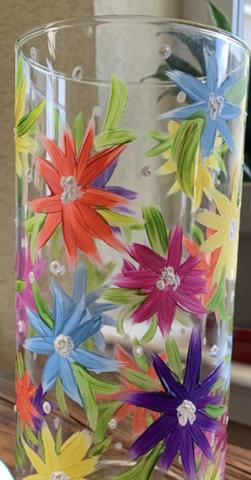Image of the craft featuring a glass vase with colorful painted daisy like flowers