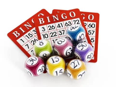 Image of BINGO Cards and balls with numbers on them 