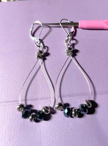 Image of the craft featuring wire earrings in a drop shape with beads. 