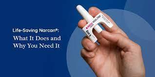 image of a hand holding a Narcan vial nasal spray.