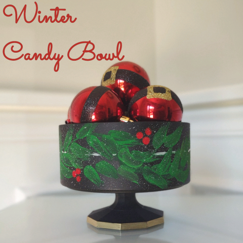 Image of the craft featuring a metal bowl with stand painted with holly. 