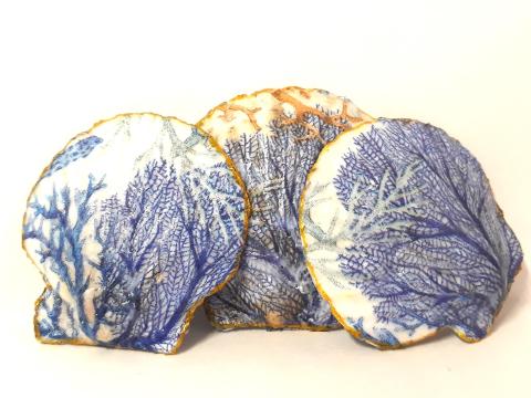 Image of the craft featuring 3 large scallop shells with a decoupaged design on them