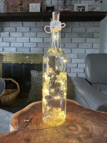 Image of the craft featuring a decorated wine bottle with LED lights in it.