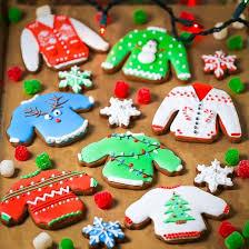 variety of cookies decorated as ugly holiday sweaters