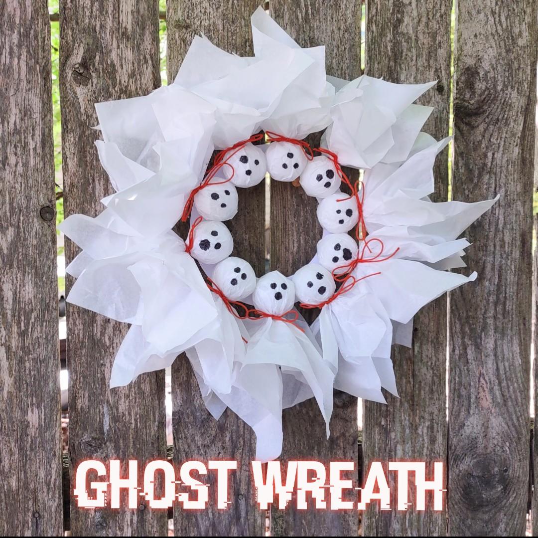Image of the craft featuring small white ghost dolls put together in a circular fashion to create a wreath. 