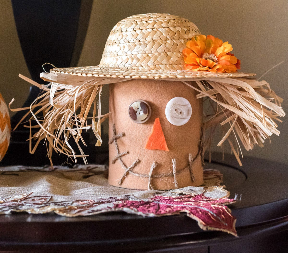 Image of a scarecrow head made from an upside down and decorated coffee can